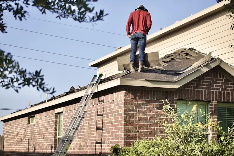 Professional roofer working on a residential roof in Polaris
